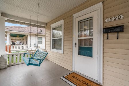 cairo st bungalow front porch blue swing welcome mat