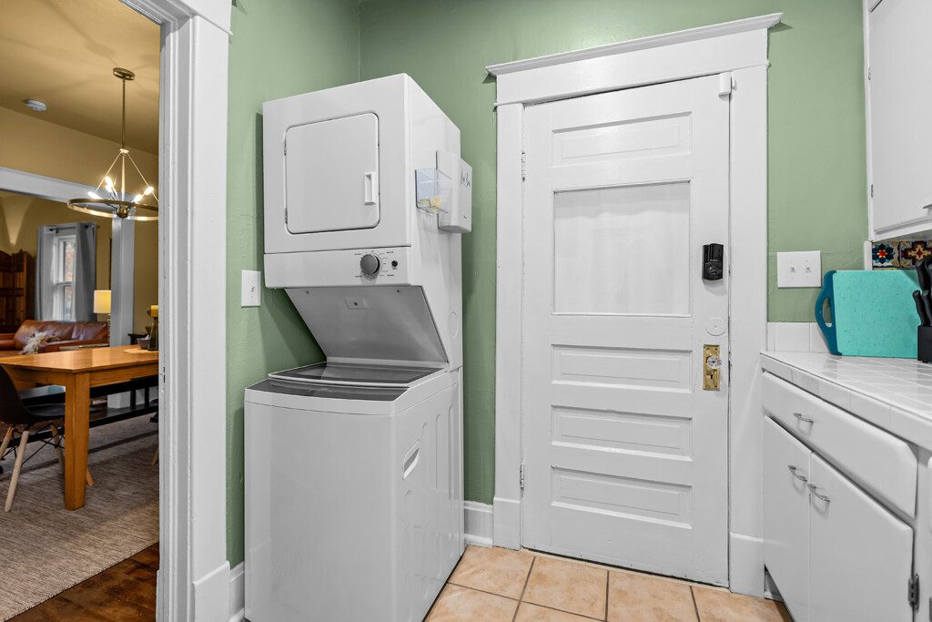 cairo st bungalow laundry area stacked washer dryer green wall