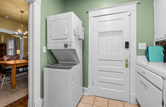 cairo st bungalow laundry area stacked washer dryer green wall