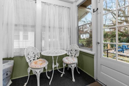 cairo st bungalow sunroom white bistro set backyard view
