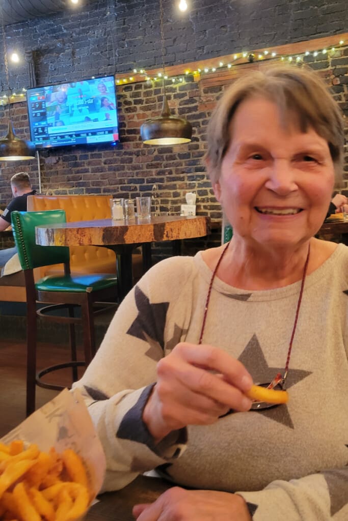 black sheep dining room senior woman fries tv.jpg Top burger spot for things to do in Springfield MO